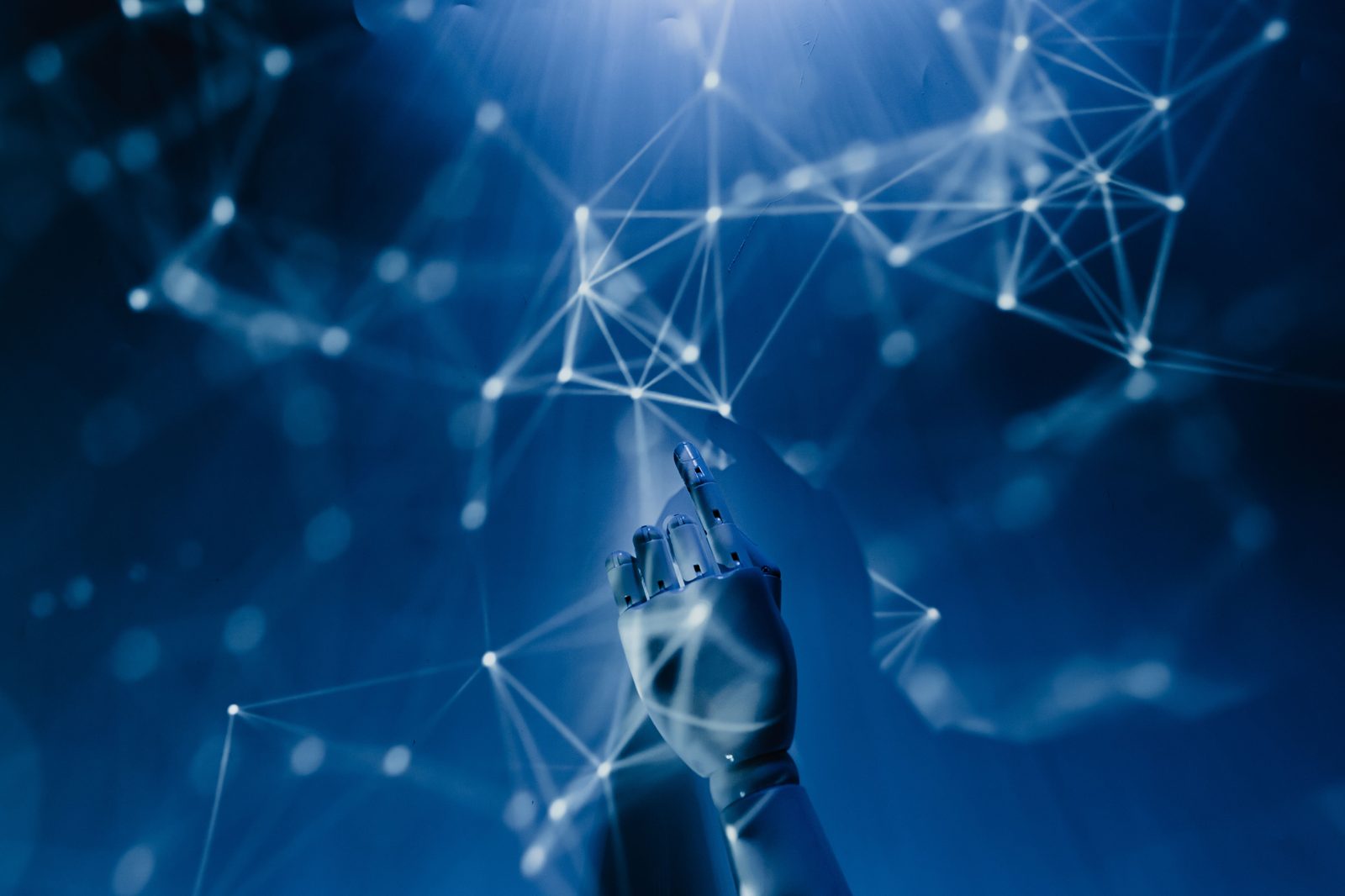 Robotic hand reaching toward a connected digital network